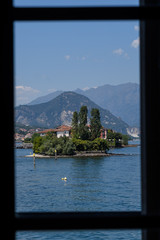 Scenic view towards Isola dei Pescatori on Lake Maggiore, Italy, view from a window