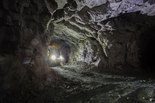 Underground gold ore mine shaft tunnel gallery passage with LHD machine