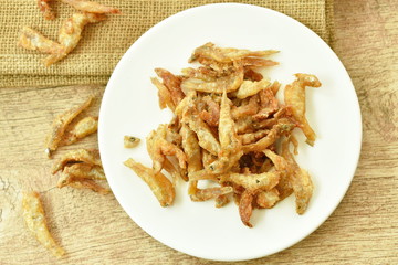 crispy fried anchovy fish with salt on plate