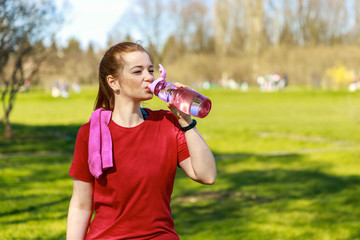 Beautiful woman after workout: tired but happy about progress. Water hydration balance