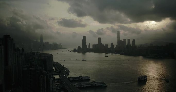 Drone aerial shot of Hong Kong Island sunset with modern skyscraper high-rises. Hong Kong is a popular tourist travel destination in Asia. Storm clouds. 
