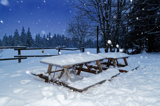 Wooden garden set from table and benches in a winter