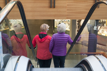 KOTKA, FINLAND - SEPTEMBER 27, 2018: Two woman on the escalator in the Shopping Center Pasaati....