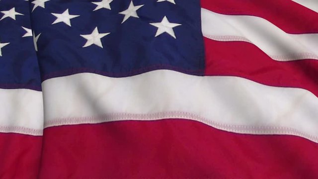 American flag in slow motion. The flag is made on the basis of a fabric smoothly developing in the wind