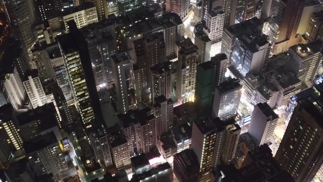 Drone shot looking down street of Hong Kong Kowloon with modern skyscraper