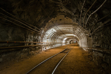 Underground gold ore mine shaft tunnel gallery with light