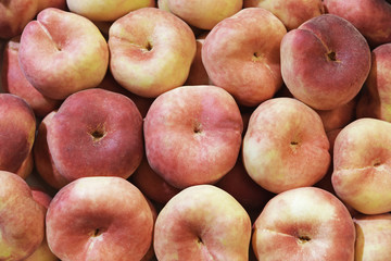 A lot of doughnut peach or flat peach full frame.