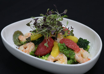 prawns and citrus fuits salad in a serving bowl