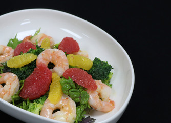prawns and citrus fuits salad in a serving bowl