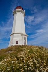 Fototapeta na wymiar White Lighthouse in Blue Sky