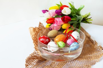 Group of easter eggs and tulip bouquet.