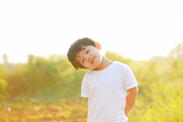 Boy smile happy in the morning, there is a backyard.