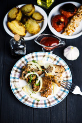Pork meat barbecue with marinated onions on a wooden background