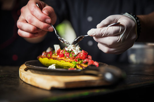 chef hands decorate dish