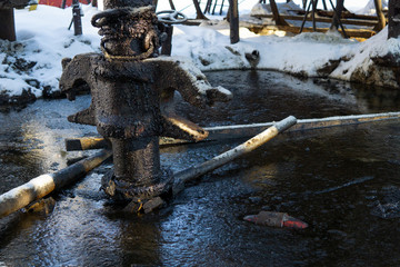 A close up of the surface of black oil pollution on water. Closeup of an oil slick in water with...