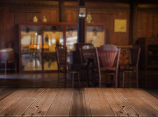 old wood table top with blurred vintage living room