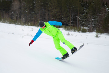 snowboarder jumping on mountain slope