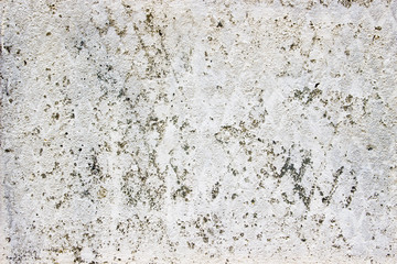 old concrete wall with a layer of whitewash, texture with ornament in the form of rhombuses