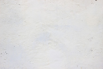 old concrete wall with a layer of whitewash, stucco texture