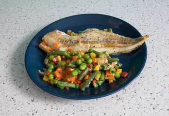 Pollock with vegetables on a plate