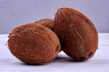 Coconuts on wooden background. Healthy tropical fruits. Exotic food concept.