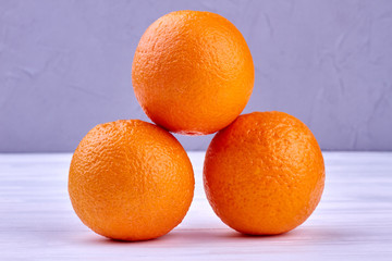 Three whole orange fruits. Oranges fruits background. Healthy eating concept.