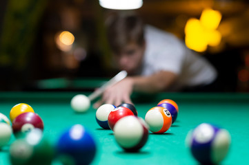 Young man playing pool in pub