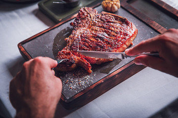 delicious steak on the table that cuts a man