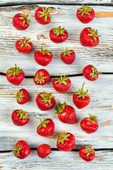 Wooden background with fresh strawberries. Ripe organic strawberries on old wooden background. Healthy food and diet.