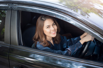 Fototapeta na wymiar Beautiful woman is driving her car