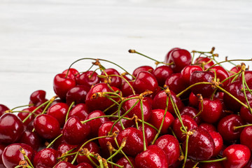 Pile of ripe cherries close up. Heap of red cherries with water drops and copy space. Fruits and vitamins.