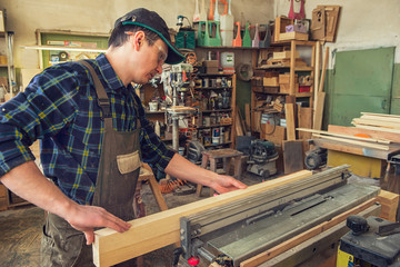 Carpenter planed wooden block with electric machine