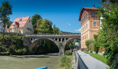 Fototapeta na wymiar Riverside scenery in Murau. Murau is a historic town in Upper Styria in the valley of the Mur in Austria.