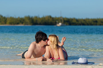 Young lovely couple kissing at the beach. Romantic vacation