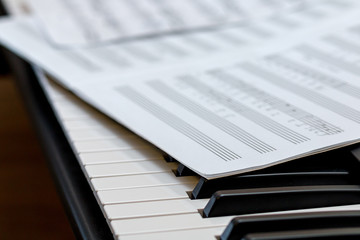 Fototapeta na wymiar Music book on the piano keys. Selective focus.