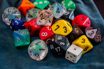 various polyhedral game dice strewn about on a table