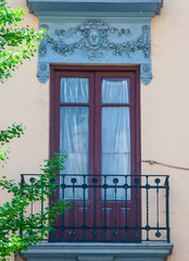 Fototapeta na wymiar wooden window with decoration and balcony in sothern spain