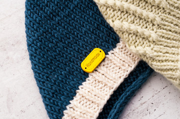 Children's woolen knitted hats on a light background. Child care concept. DIY