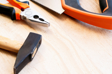 Hammer, nails and pliers lie on a wooden background. Construction Tools Selective Focus.