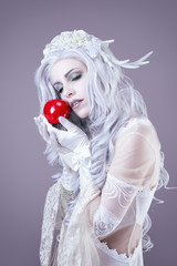 Young princess holding an apple in her hand