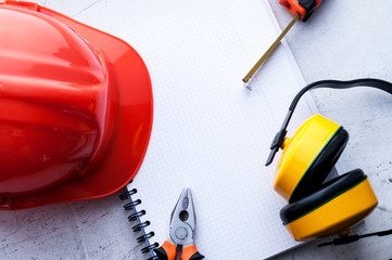 Construction helmet is a symbol of safety in the workplace. Set of tools. Safety concept Selective focus.