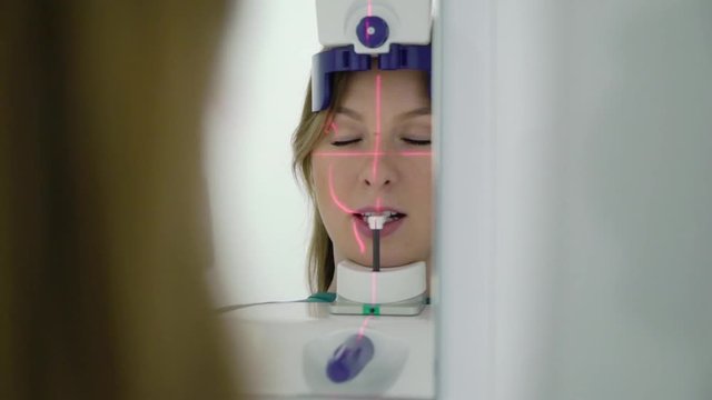 Woman patient in X-ray machine scanner in medical cabinet in hospital. Work place of doctor in clinic. Healthcare