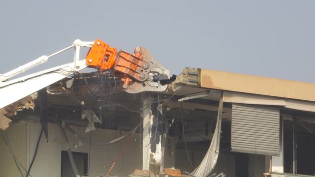 Building Demolition with a Hydraulic Excavator