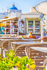 Closeup of Wooden Chairs of Open Air Restaurant Located in Oia Village in Santorini Island in Greece.