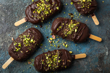 homemade vanilla ice cream with chocolate glaze and pistachios
