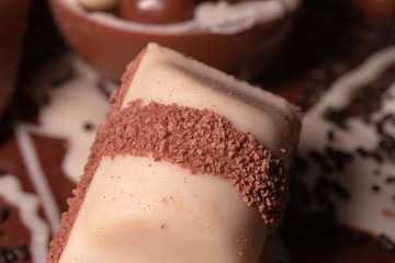 Chocolate, chocolate cookies and candies like a decoration on homemade cake