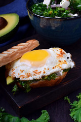 Sandwich with fried egg with liquid yolk and kale cabbage