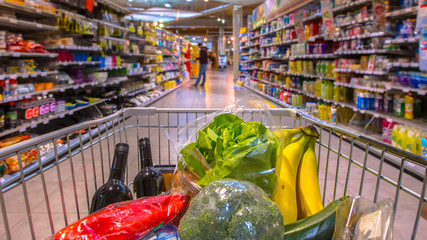Grocery cart in supermarket pano - obrazy, fototapety, plakaty