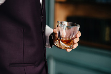 A glass of brandy in male hand