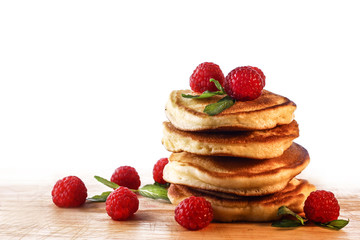  Pancakes. Homemade pancakes with raspberries on a wooden board.